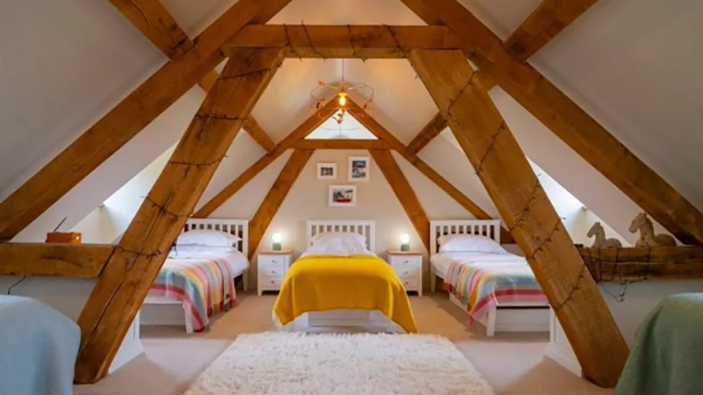 Cosy holiday let bedroom with exposed wooden beams